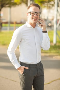 Man with glasses speak on mobile phone, In City, Urban Space, Park