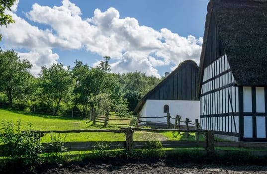 Farmland with old fence around and timbered buildings