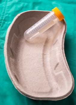 Medical Stethoscope lying on the hospital's green background. The background can be a textile part of a doctor or nurse's work uniform