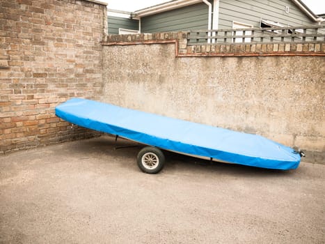 close up of boating vessel parked on land with blue cover  England  UK