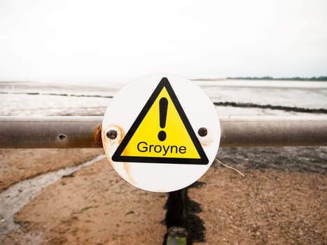close up of exclamation yellow triangle groyne on metal pole  England  UK