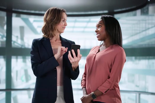 African American woman giving career pitch in elevator conversation