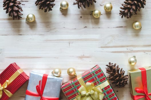 Christmas background with decorations and gift boxes on wooden table. Top view with copy space.