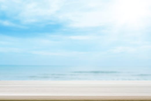 Empty wooden table top with blurred sea and sky background. can be used product display.