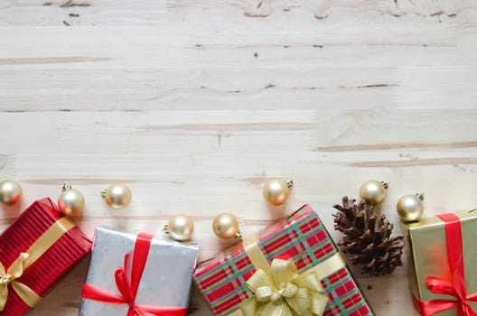 Christmas background with decorations and gift boxes on wooden table. Top view with copy space.