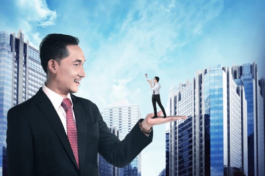 Giant business man holding little man yelling with megaphone. Politic in business