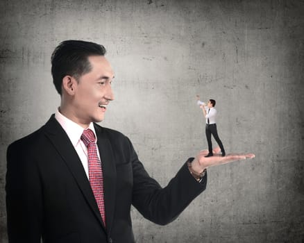 Giant business man holding little man yelling with megaphone. Politic in business