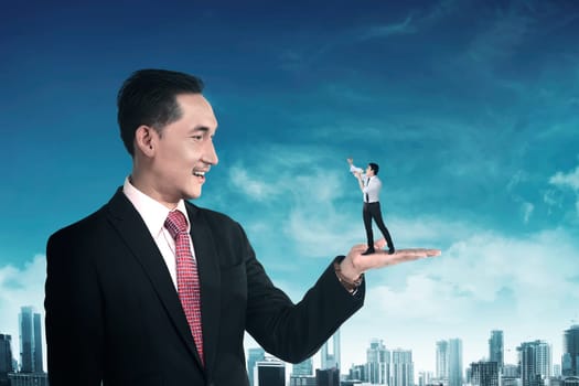 Giant business man holding little man yelling with megaphone. Politic in business