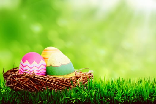 Decorated egg inside the nest. Happy easter concept