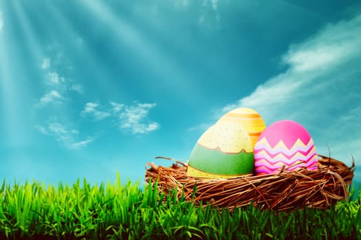 Decorated egg inside the nest. Happy easter concept