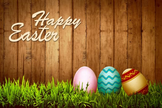 Colorful egg on the grass over wooden background. Happy easter concept
