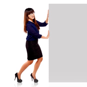 Pretty asian brunette businesswoman in happy face showing an empty blankboard isolated on white background