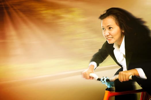 Businesswoman in a rush riding a bicycle in a sunny day showing motion movement to reach a goal