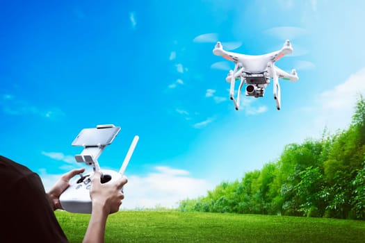 Male pilot controlling drone with remote control