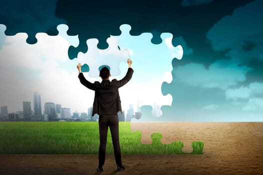 Business person building puzzle of city in the desert. Business building concept