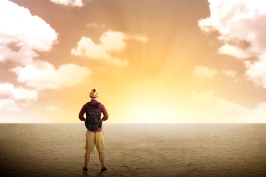 Traveler trekking in the desert with cloudy sky