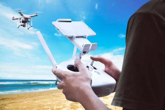 Male pilot controlling drone with remote control