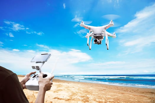 Male pilot controlling drone with remote control