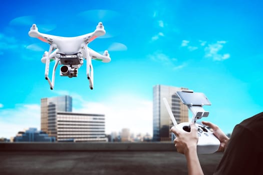 Male pilot controlling drone with remote control