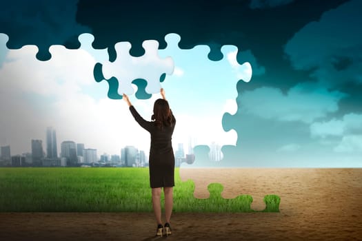 Business person building puzzle of city in the desert. Business building concept