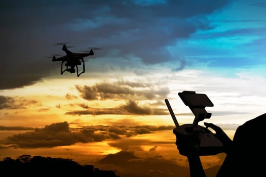 Male pilot controlling drone with remote control