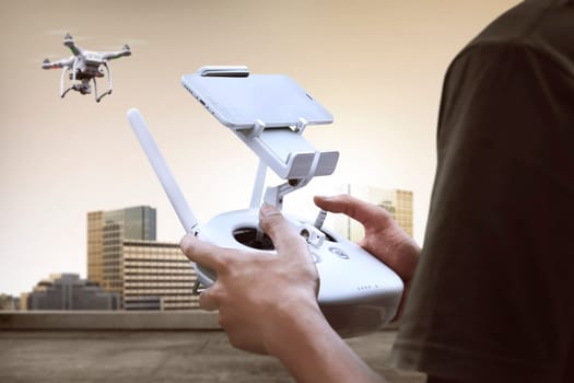Male pilot controlling drone with remote control