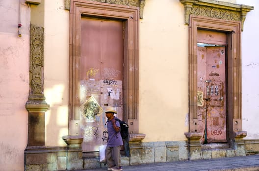 OAXACA, MEXICO - MARCH 4: Pink facade with a man passing by in downtown in Oaxaca, Mexico on March 4, 2017