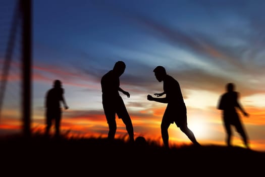 Silhouette of soccer player ready kick ball on the field