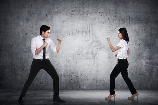 Business man and woman fighting. Working competition concept