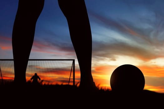 Silhouette of soccer player ready to execute penalty kick on the field