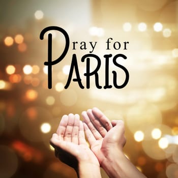 Human hand pray for paris incident, with blur city background