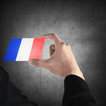 Man hand hold transparent card with france flag. Independence day concept