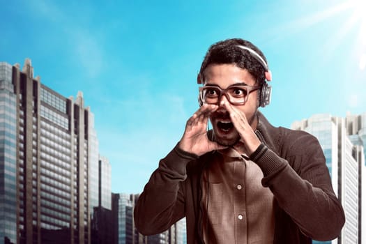 Asian man wearing headphone and shouting with mouth