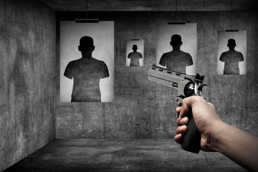 Man hand holding gun on the shooting range
