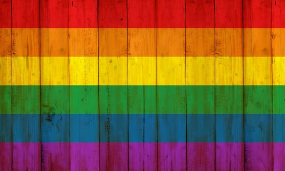 Gay flag rainbow on wooden fence texture. LGBT Concept