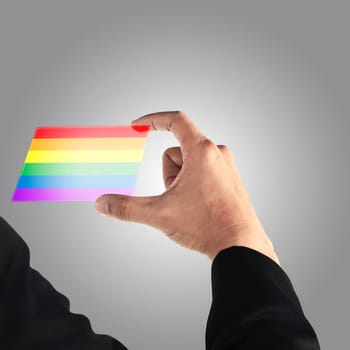Man hand holding gay pride transparent card on grey background