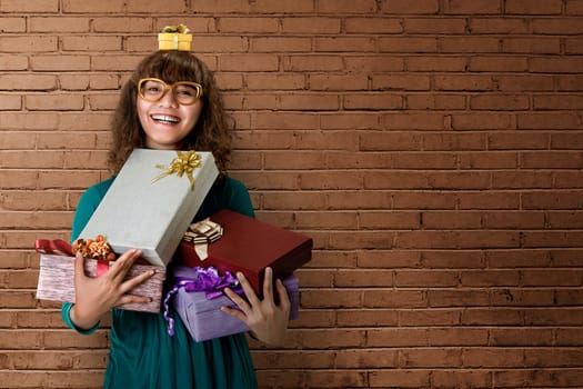 Asian woman smiling full of excitement, with a few gifts in her hands