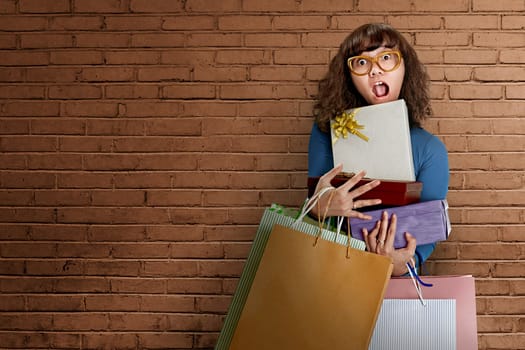 Asian woman wearing glasses, she is carrying a lot of gifts and bags