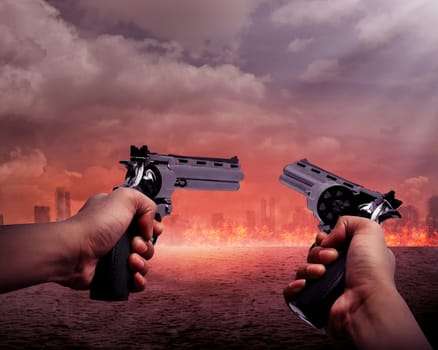 Man hand holding two gun and aiming to the burn city