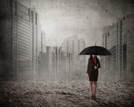 Asian business woman holding umbrella over city background