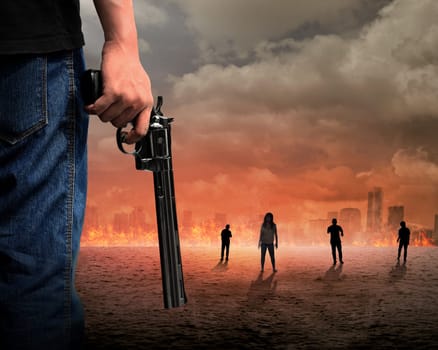 Man hand holding gun with zombie and burn city background