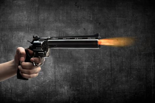 Man hand holding gun and firing it