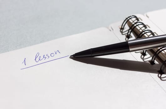 first lesson open notebook with pen can be background