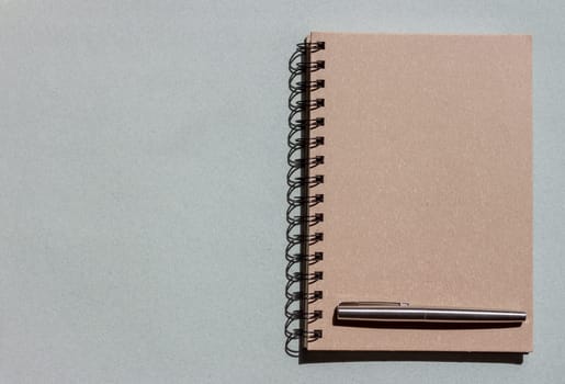top view craft notebook and pen on blue background