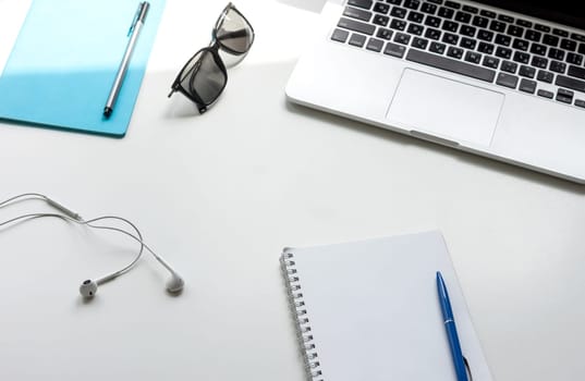 work desk with laptop notebook and glasses