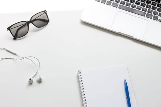 work desk with laptop notebook and glasses