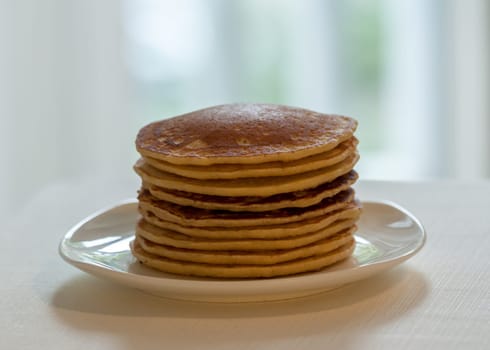 homemade american pancakes breakfast on light blurred background