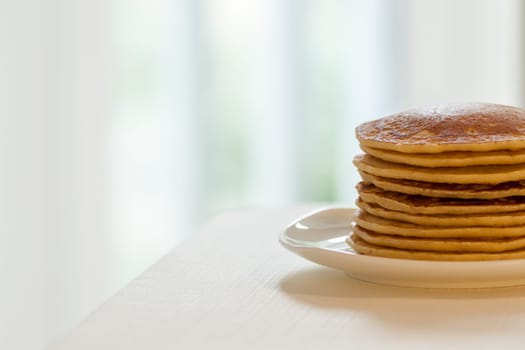 homemade american pancakes breakfast on light blurred background