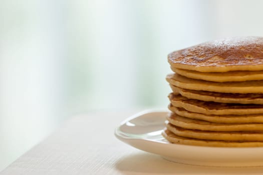 homemade american pancakes breakfast on light blurred background