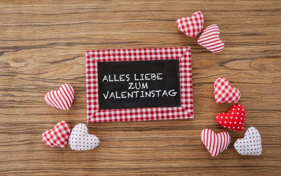 Small panel with colorful hearts on a wooden background